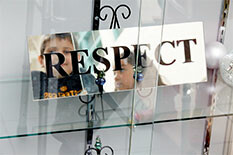 a sign in a glass case bearing the word "Respect"